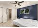 Bedroom with dark blue accent wall and light gray flooring; bathroom attached at 1827 E Jarvis Ave, Mesa, AZ 85204