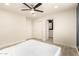 Spacious bedroom featuring gray flooring, white walls, and a ceiling fan at 1827 E Jarvis Ave, Mesa, AZ 85204