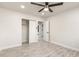 Bedroom showcases wood-look tile flooring, ceiling fan, and an open closet at 1827 E Jarvis Ave, Mesa, AZ 85204