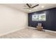 Bedroom features a large window, ceiling fan, and wood-look tile flooring at 1827 E Jarvis Ave, Mesa, AZ 85204