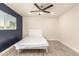 Bright bedroom with ceiling fan, and modern gray flooring and a navy blue accent wall at 1827 E Jarvis Ave, Mesa, AZ 85204