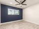 Bedroom features a large window, ceiling fan, and wood-look tile flooring at 1827 E Jarvis Ave, Mesa, AZ 85204