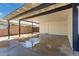 View of the spacious covered carport with brick accent wall and door to interior at 1827 E Jarvis Ave, Mesa, AZ 85204