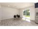 Open-concept dining area featuring gray tile flooring, a sliding glass door, and modern chairs at 1827 E Jarvis Ave, Mesa, AZ 85204