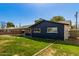 This exterior shot showcases a well-maintained lawn and a cozy single-story home at 1827 E Jarvis Ave, Mesa, AZ 85204