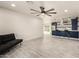 Spacious open-concept living room and kitchen featuring tile floors and modern ceiling fan at 1827 E Jarvis Ave, Mesa, AZ 85204