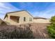 Low-maintenance backyard with gravel and covered patio at 18621 W Hackamore Dr, Surprise, AZ 85387