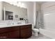 Bathroom featuring a large mirror, and a shower over bath at 18621 W Hackamore Dr, Surprise, AZ 85387