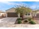 Charming single-story home with a well-manicured lawn and a two-car garage at 18621 W Hackamore Dr, Surprise, AZ 85387