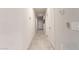 A hallway with tile flooring leading to the front door and other rooms at 18621 W Hackamore Dr, Surprise, AZ 85387