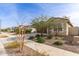 A neighborhood street view of a single-story home with desert landscaping at 18621 W Hackamore Dr, Surprise, AZ 85387