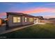 Expansive backyard featuring a pristine lawn, tiled patio, and block fencing for enhanced privacy at 19797 W Lincoln St, Buckeye, AZ 85326