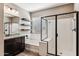 Modern bathroom featuring a soaking tub, glass shower, and dark cabinets with granite countertop at 19797 W Lincoln St, Buckeye, AZ 85326