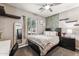 Bedroom with dark wood bed frame and furniture, large window with natural light at 19797 W Lincoln St, Buckeye, AZ 85326