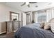 Comfortable bedroom featuring natural light, a dresser with a mirror and a large bed at 19797 W Lincoln St, Buckeye, AZ 85326