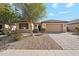 Charming single-story home featuring a tile roof, desert landscaping, and a two-car garage at 19797 W Lincoln St, Buckeye, AZ 85326