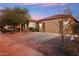 Charming single-story home showcasing a spacious three-car garage, stone accents, and low-maintenance landscaping at 19797 W Lincoln St, Buckeye, AZ 85326