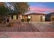 Charming single-story home featuring a tile roof, desert landscaping, and a two-car garage at 19797 W Lincoln St, Buckeye, AZ 85326