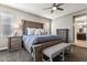 Serene main bedroom featuring a large bed, carpeted floors, and an ensuite bathroom at 19797 W Lincoln St, Buckeye, AZ 85326