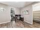 Office features wood floors, multiple monitors, and adjacent access to a bedroom and closet at 19797 W Lincoln St, Buckeye, AZ 85326