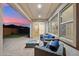 Inviting outdoor patio with wicker seating surrounding modern gas fire pit and outdoor lounge area at 19797 W Lincoln St, Buckeye, AZ 85326