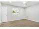 This bedroom features neutral walls, neutral carpet, a ceiling fan, and a window at 2032 W Eugie Ave, Phoenix, AZ 85029