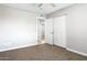 Cozy bedroom featuring neutral carpet, closet, and a view to the hallway at 2032 W Eugie Ave, Phoenix, AZ 85029