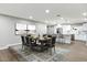 Dining area featuring wood floors, a modern rug, and an open view into the bright kitchen at 2032 W Eugie Ave, Phoenix, AZ 85029