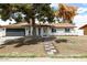 Charming single-story home featuring a brick exterior, a dark gray garage door, and a landscaped front yard at 2032 W Eugie Ave, Phoenix, AZ 85029