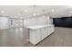 Open-concept living area featuring wood floors, recessed lighting, and a large kitchen island with pendant lights at 2032 W Eugie Ave, Phoenix, AZ 85029