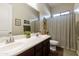 Bathroom with double sinks, decorative art, and a shower/tub combination at 20594 S 194Th Pl, Queen Creek, AZ 85142