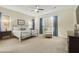 Relaxing main bedroom features neutral tones, plantation shutters, and a cozy sitting area at 20594 S 194Th Pl, Queen Creek, AZ 85142