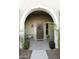 Charming front porch with olive-tone walls, a bench, plants, and a wreath on the front door at 20594 S 194Th Pl, Queen Creek, AZ 85142