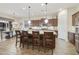 Open concept kitchen with a large island, stainless steel appliances, and seamless flow to the dining area at 20594 S 194Th Pl, Queen Creek, AZ 85142