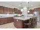 Spacious kitchen features a large center island with seating, stainless steel appliances, and beautiful cabinetry at 20594 S 194Th Pl, Queen Creek, AZ 85142