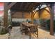 Covered outdoor dining area with seating for six under a wood pergola on a stone paver patio at 20594 S 194Th Pl, Queen Creek, AZ 85142