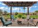 Inviting backyard with seating around a fire pit on a paved patio at 20780 N Gardenia Rd, Maricopa, AZ 85138