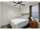 This bedroom features a ceiling fan, plush carpet, and natural light from the exterior window at 20780 N Gardenia Rd, Maricopa, AZ 85138