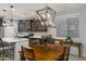 Charming dining area with dark wood table and decorative lighting, adjacent to the kitchen at 20780 N Gardenia Rd, Maricopa, AZ 85138