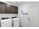 Bright laundry room with washer, dryer, and storage cabinets at 20780 N Gardenia Rd, Maricopa, AZ 85138