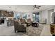 Inviting living room with comfortable seating, a ceiling fan, and an open layout connecting to the kitchen at 20780 N Gardenia Rd, Maricopa, AZ 85138