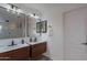 Modern bathroom with dual sinks, wood vanities, and updated fixtures at 21266 E Via De Olivos --, Queen Creek, AZ 85142