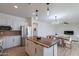 Open-concept kitchen featuring white cabinets, a wood-topped island, and stainless steel appliances at 21266 E Via De Olivos --, Queen Creek, AZ 85142