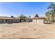 Expansive backyard features outbuildings for storage, offering room to relax and entertain at 2530 E Randall Dr, Tempe, AZ 85288