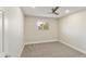 Carpeted bedroom with neutral walls, baseboards, and a view out the window at 2530 E Randall Dr, Tempe, AZ 85288