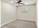 A carpeted bedroom featuring neutral walls, baseboards, and ceiling fan at 2530 E Randall Dr, Tempe, AZ 85288