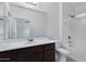 Bathroom featuring a shower-tub combo and a vanity with plenty of counter space at 2540 E Atlanta Ave, Phoenix, AZ 85040