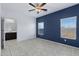 Cozy bedroom with a ceiling fan, natural light, attached bath and a stylish accent wall at 2540 E Atlanta Ave, Phoenix, AZ 85040