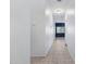 Inviting hallway with neutral paint, tile flooring, and a view into the dining room at 2540 E Atlanta Ave, Phoenix, AZ 85040