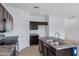 Well-lit kitchen featuring dark wood cabinets, stainless steel appliances, and durable countertops at 2540 E Atlanta Ave, Phoenix, AZ 85040